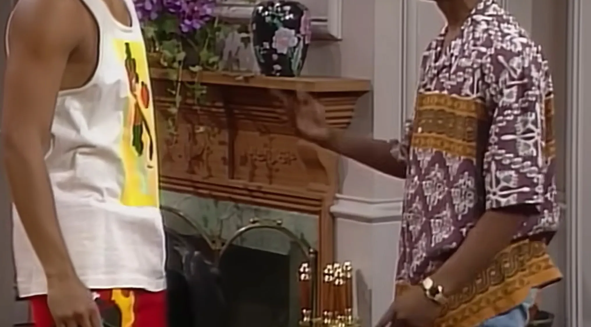 Will Smith and another character from The Fresh Prince of Bel-Air in colorful 90s fashion. Iconic TV show outfits.