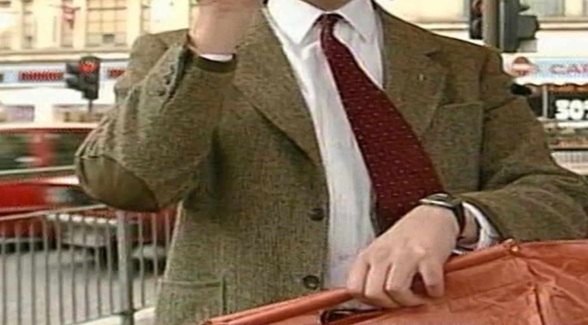 Iconic TV show outfit with a brown tweed jacket, white shirt, and red tie, holding an umbrella.