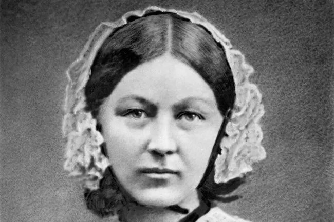 Black and white portrait of Florence Nightingale wearing a cap, looking directly at the viewer.