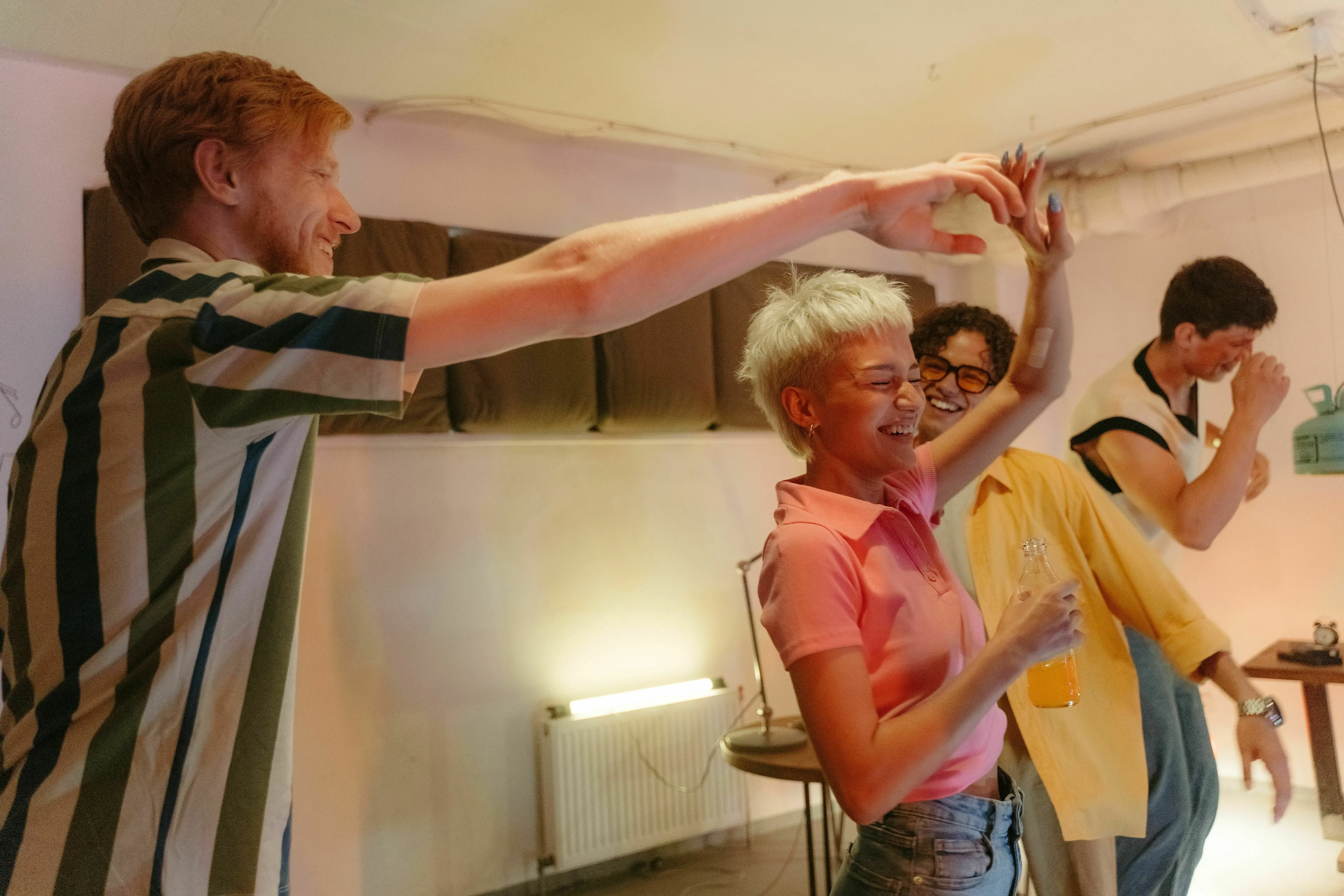 Happy diverse young people dancing at a party. What's your red flag when you don't know many people?
