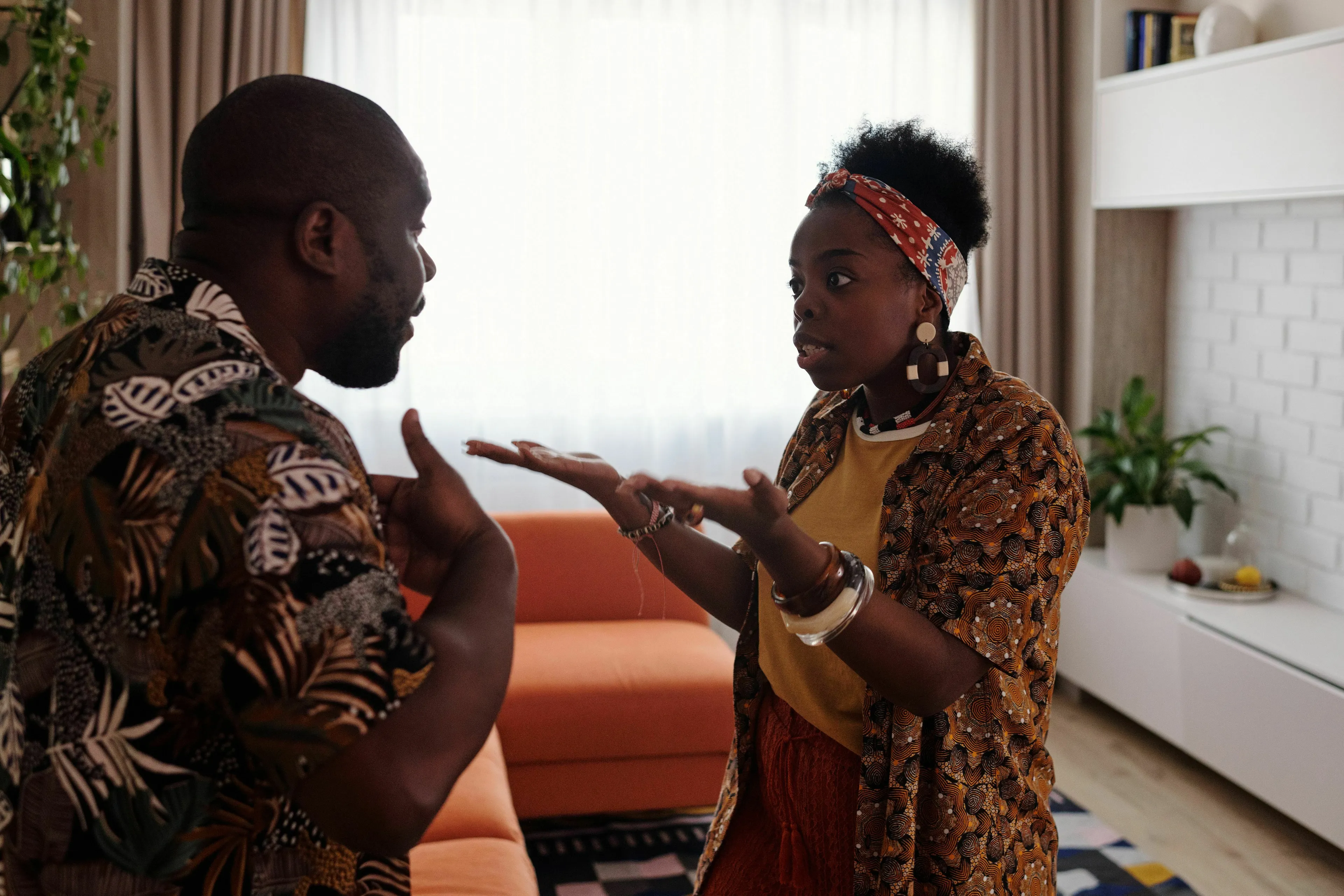 A couple arguing, woman gesticulating with open hands, discussing their Red Flag.