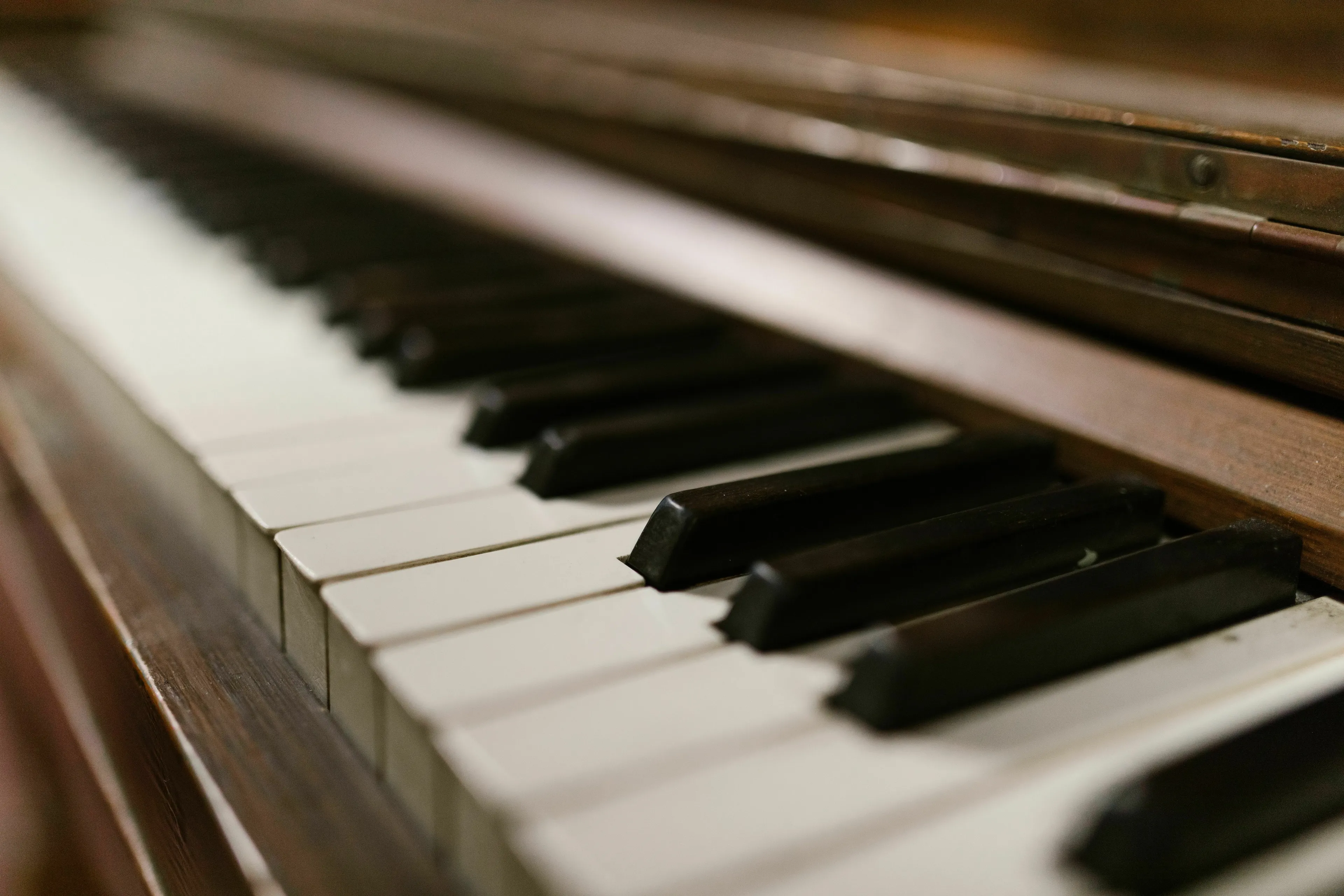 A close-up view of piano keys, both white and black, receding into a soft focus. General Knowledge Type-In.