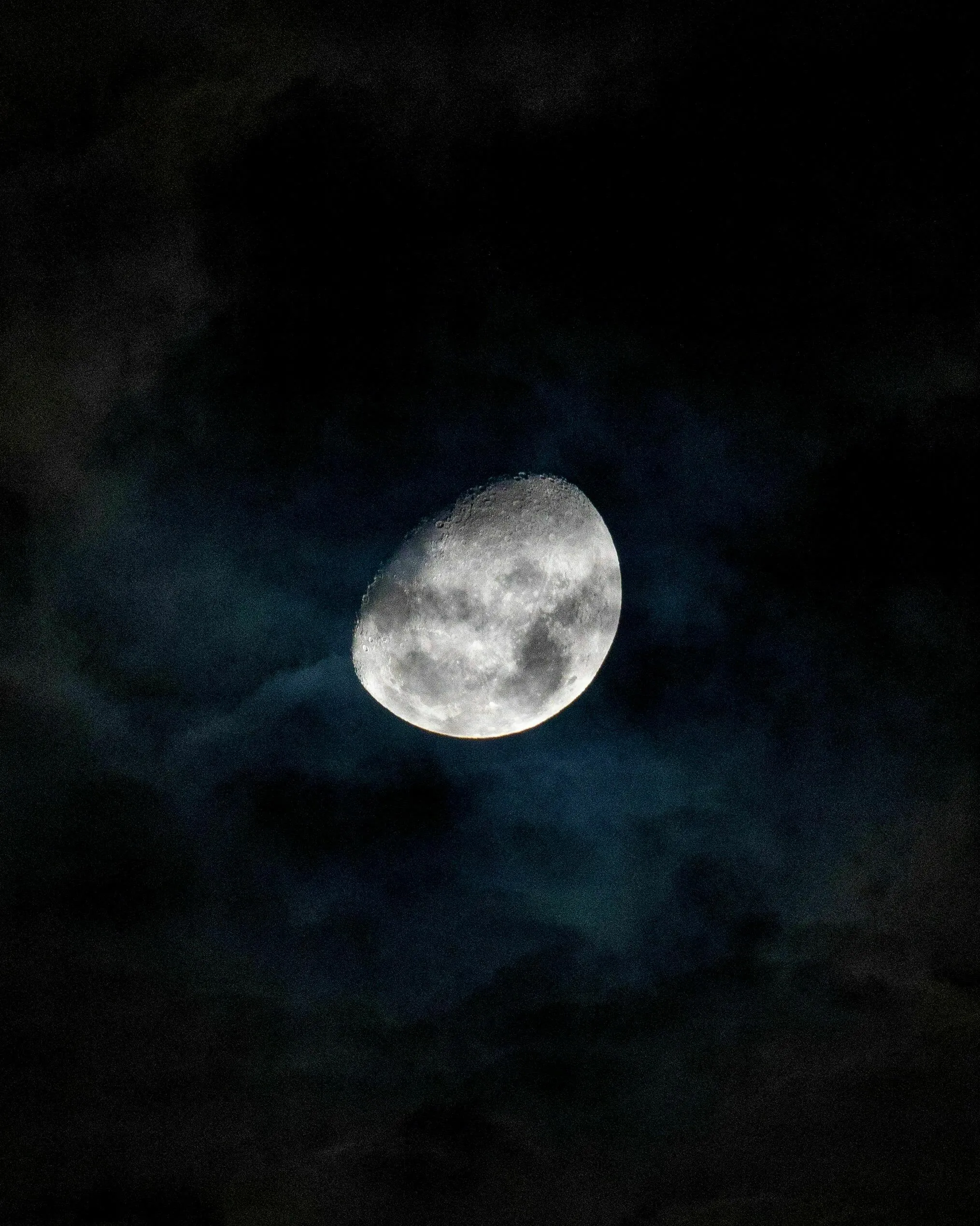 A bright crescent moon glows through dark, wispy clouds. Exploring general knowledge about the sport played on the moon.