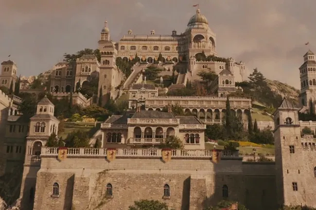 An elaborate castle with multiple towers and terraced gardens built into a hillside, reminiscent of Narnia architecture.