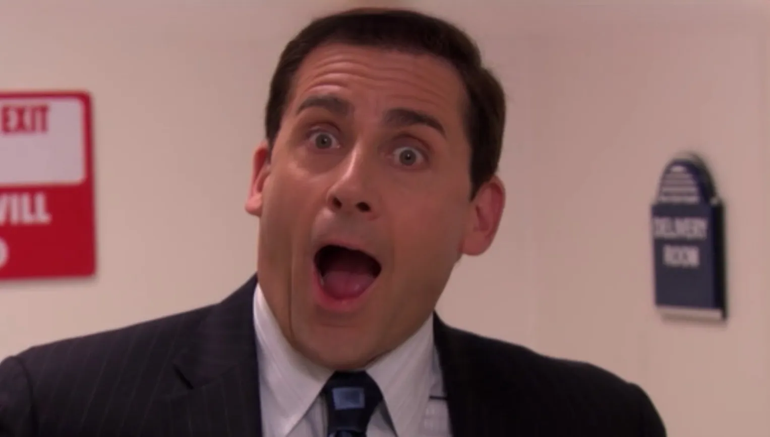 Michael Scott from The Office, wide-eyed and mouth open in surprise, a classic "That's what she said" moment.