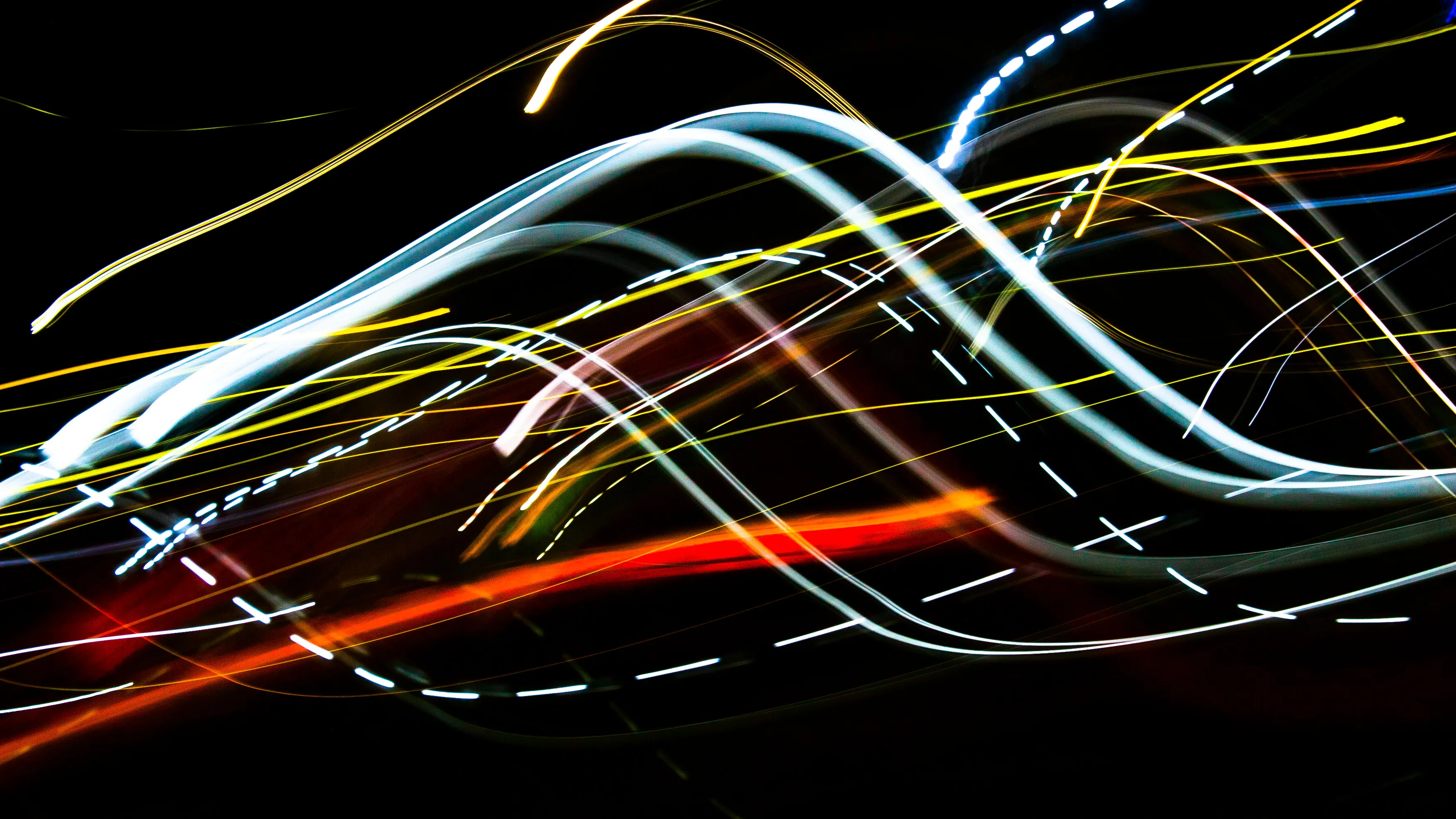 Abstract light streaks, blue, yellow, and red, bending and crossing on a dark background. Hard General Knowledge Test, High IQ.