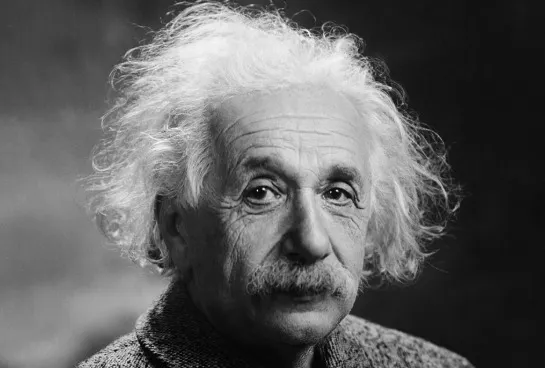 Black and white close-up of Albert Einstein, known for his work in thermodynamics and entropy, looking at the camera.