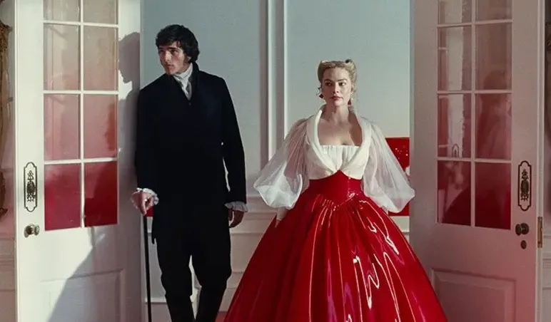 A man in black period attire and a woman in a dramatic red and white gown stand in a doorway. Well-read themes.