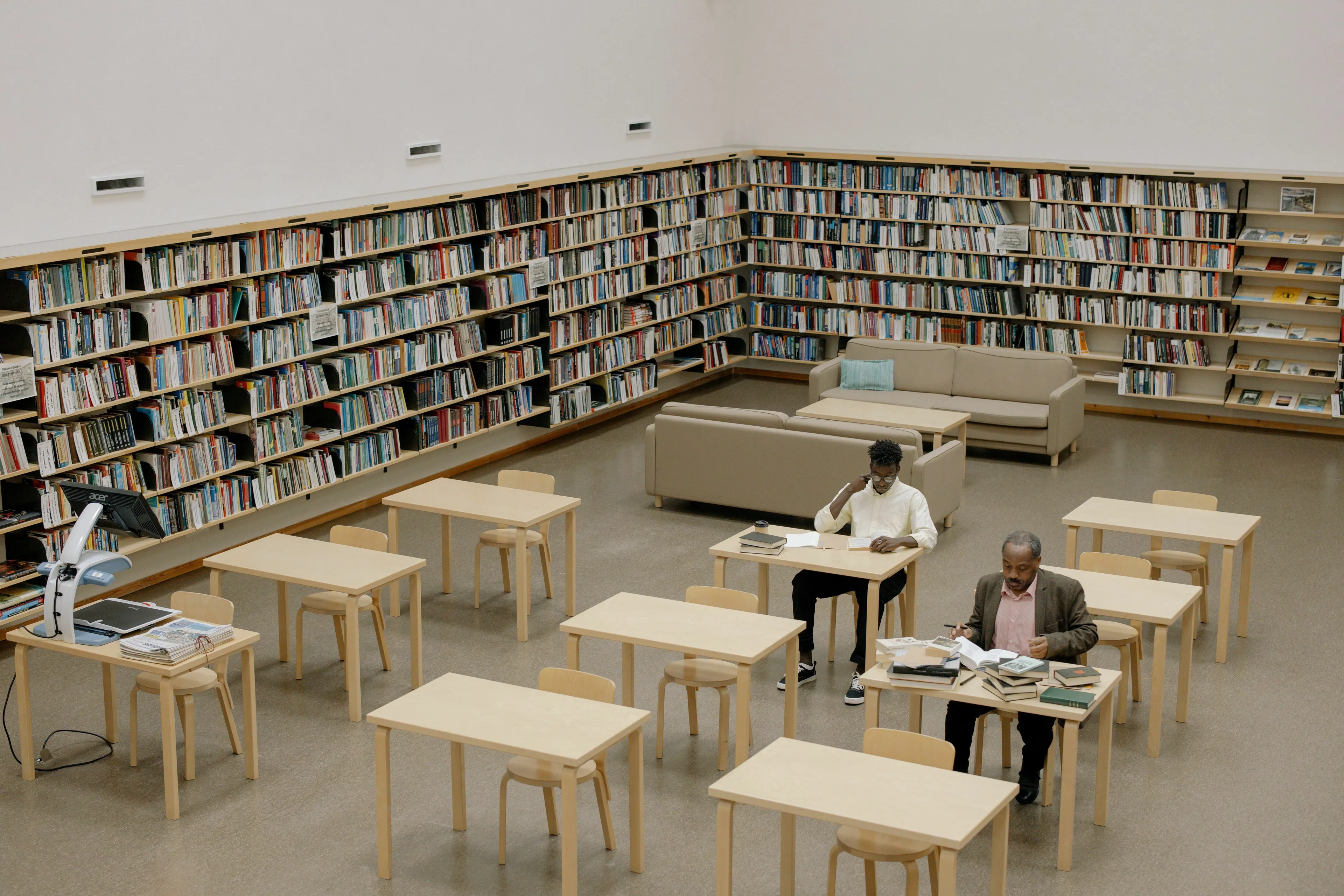 Well-read individuals studying in a library, surrounded by bookshelves. Which novel takes place over a single day?
