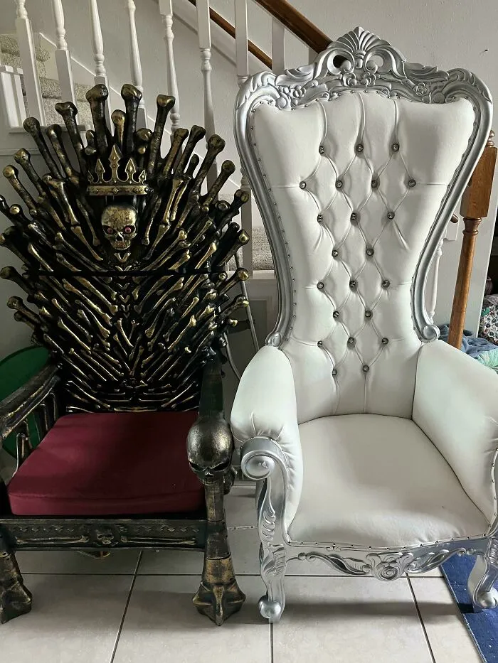 Two ornate chairs, one resembling the Iron Throne, discovered during dumpster diving.