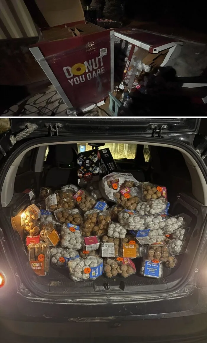 Numerous packages of donuts filling a car trunk, an abundant haul from dumpster diving.