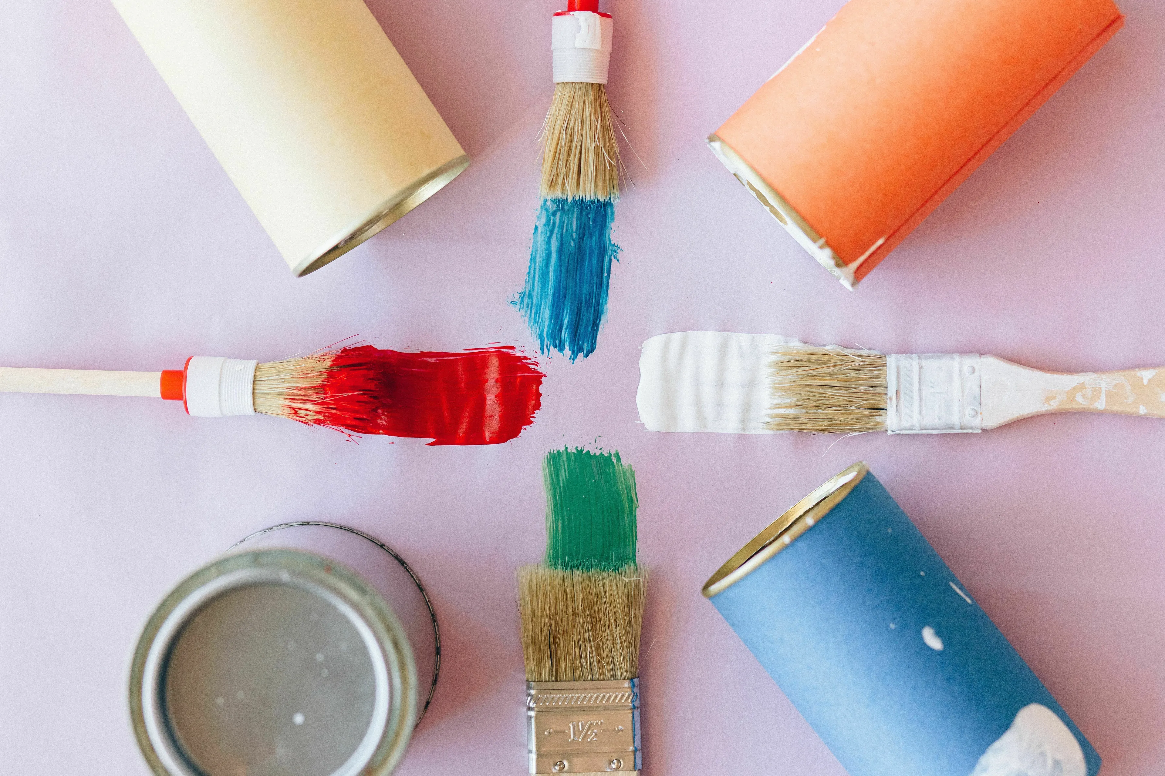 A general knowledge quiz image showing paint brushes with red, white, blue, and green paint, along with paint cans.