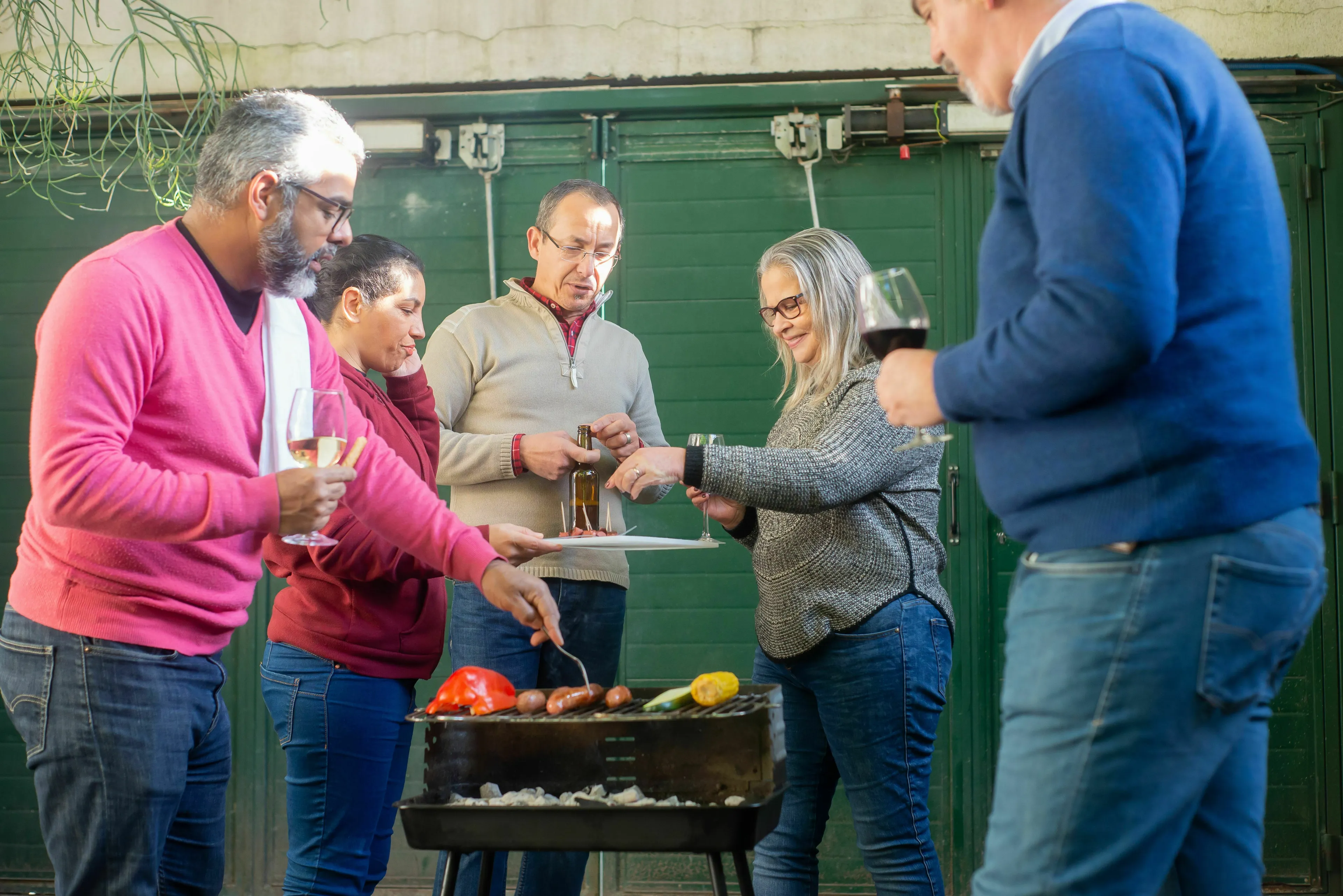Neighbors gathered at a barbecue, handling loneliness by socializing and grilling food together.