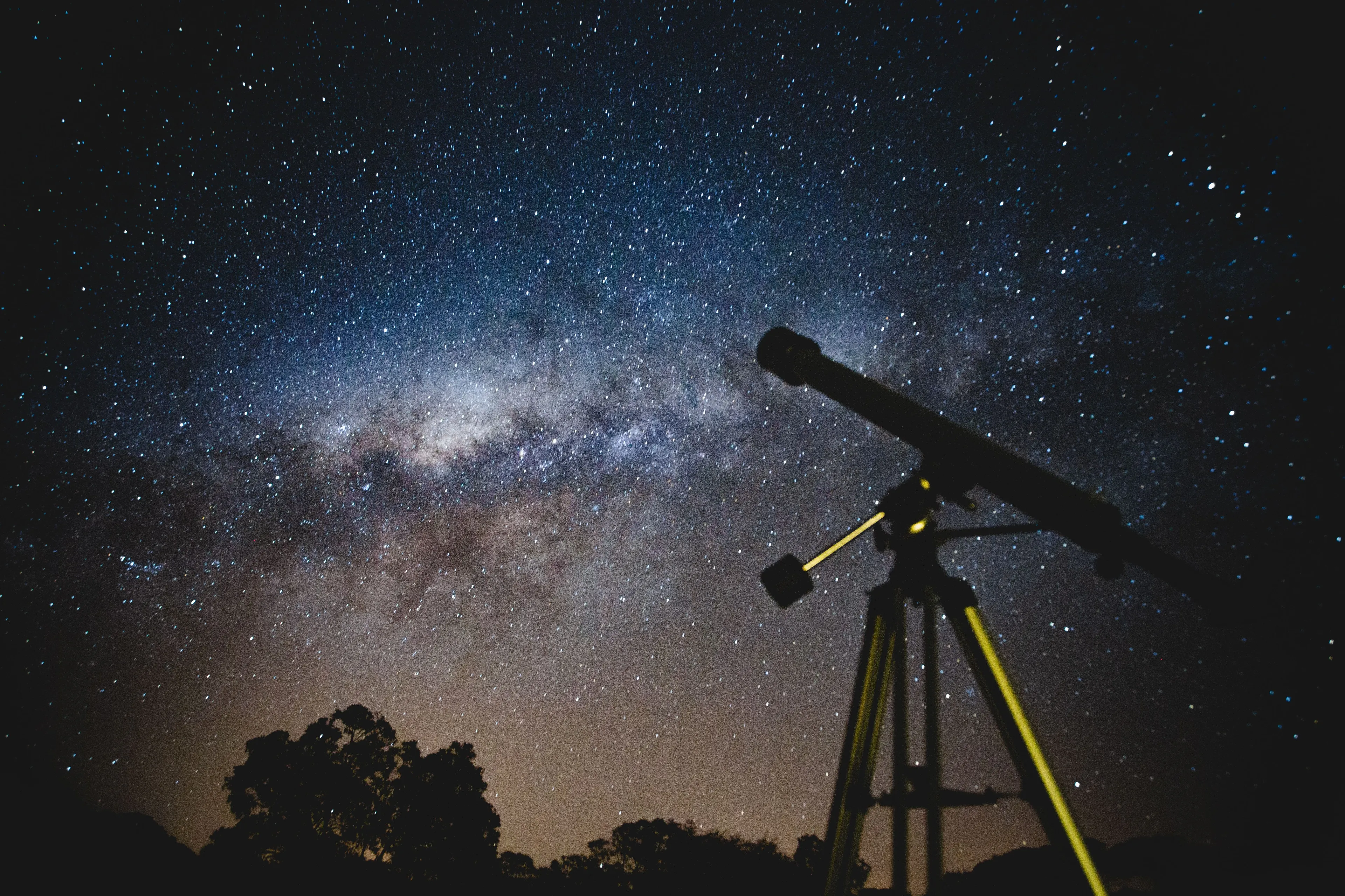 Telescope pointed towards the Milky Way galaxy in a starry night sky, ideal for a royal astronomer.