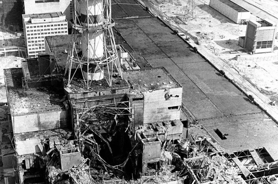 Aerial view of the Chernobyl disaster site, showing the destroyed reactor building amidst extensive damage and debris.