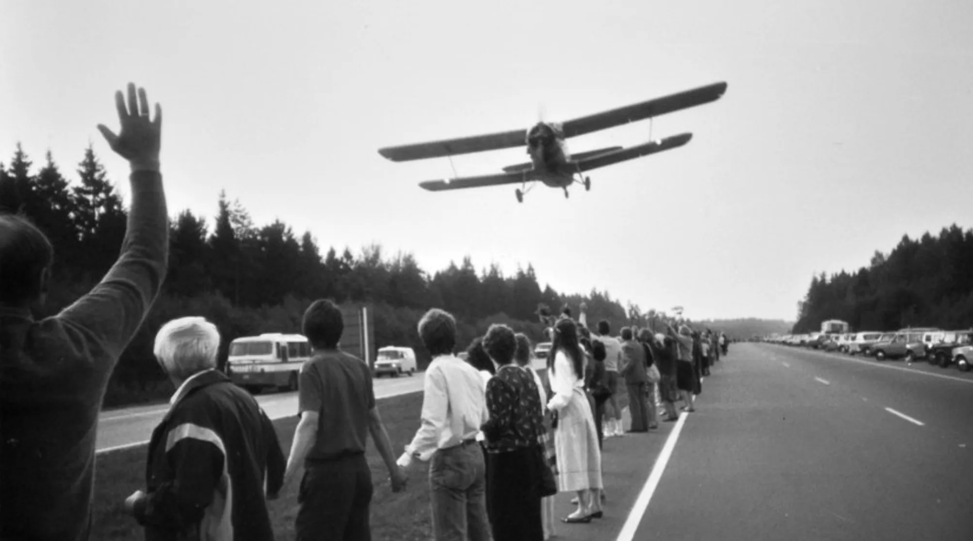Black and white photo of people forming the Baltic Way human chain in 1989 as a biplane flies overhead. General Knowledge About Europe.