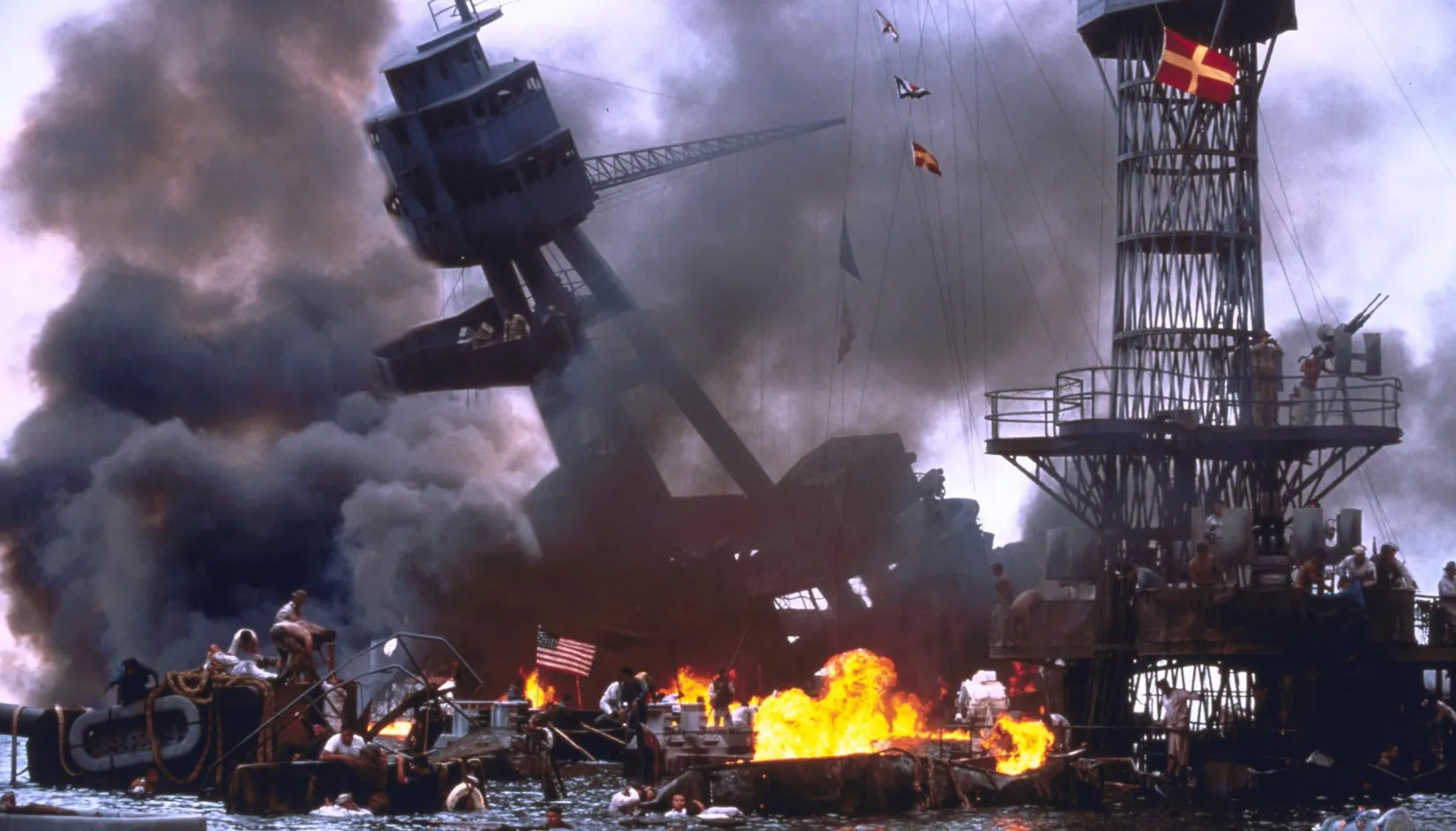 A scene of a naval battle with ships on fire and smoke, representing a significant historic event.