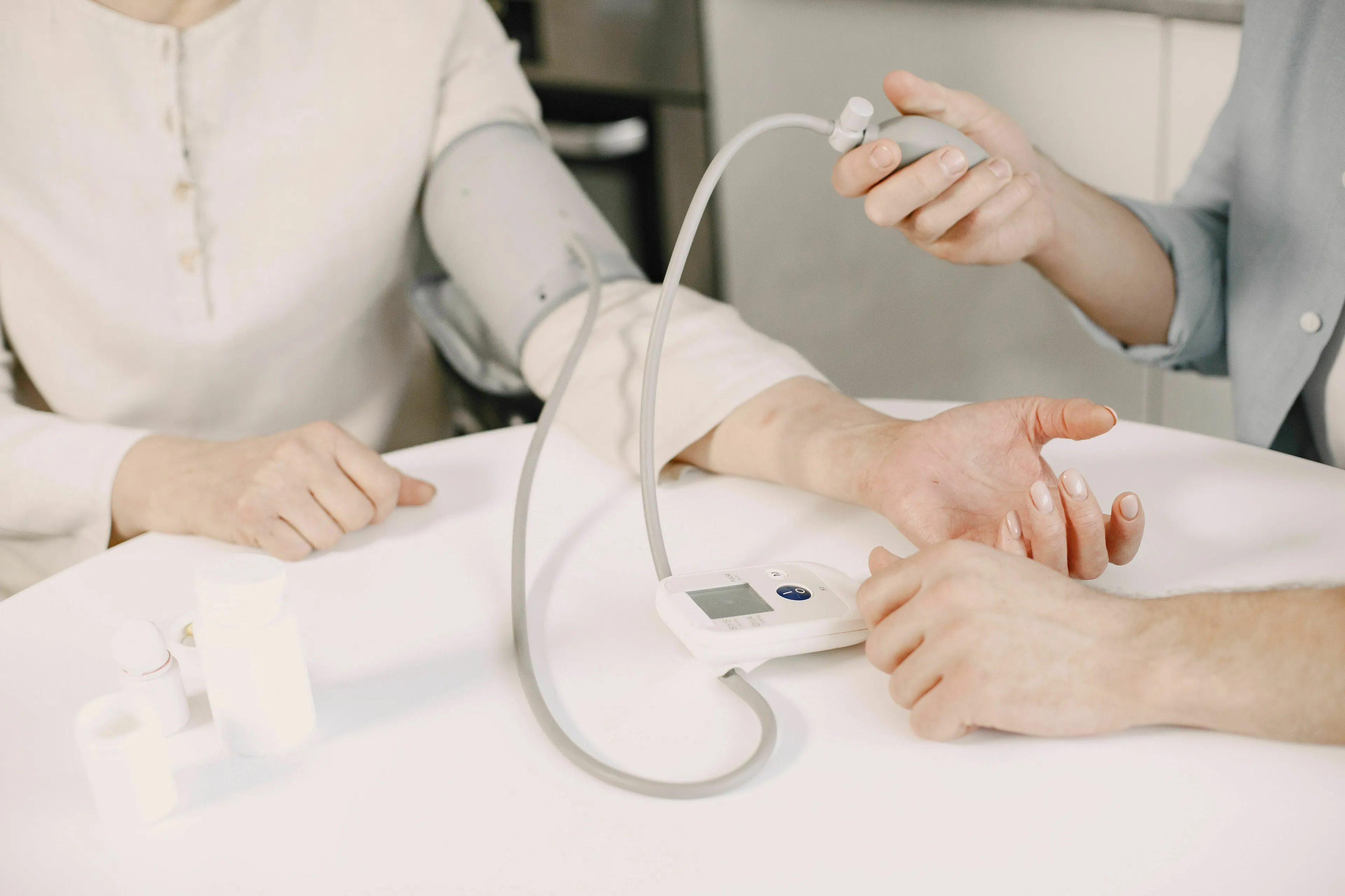 Basic Medical Knowledge Quiz: A person measuring blood pressure with an arm cuff and monitor.