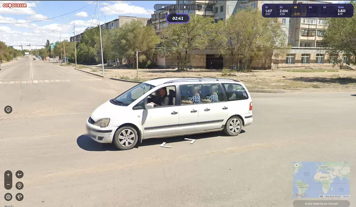 A white car driving down a street, captured in a funny Google Street View photo.