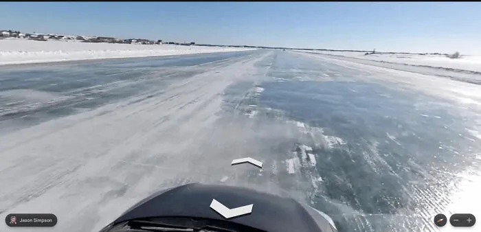 A bizarre Google Street View photo taken from a vehicle driving on an icy, snow-covered road.