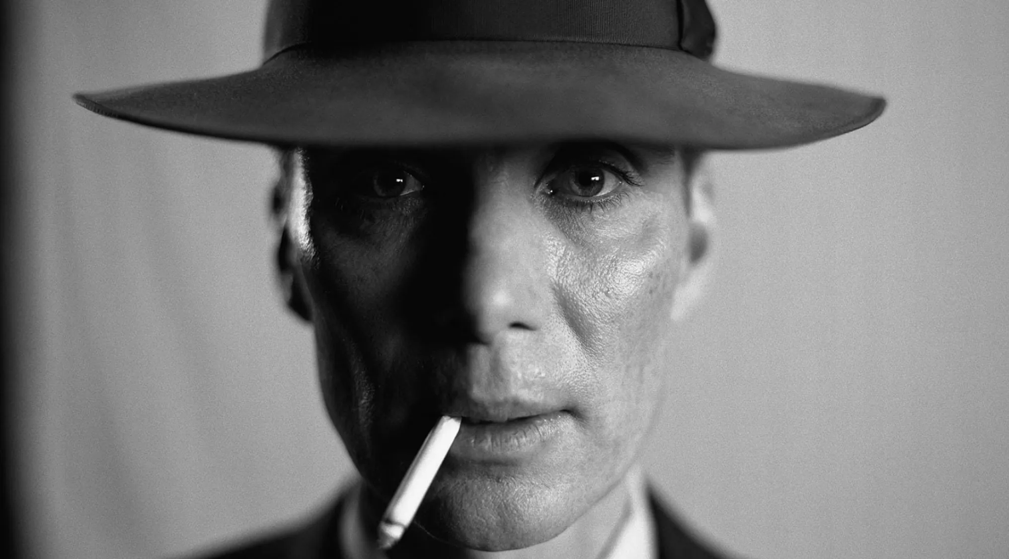 Black and white close-up of Cillian Murphy in character with a hat and cigarette, for Guess The Country.