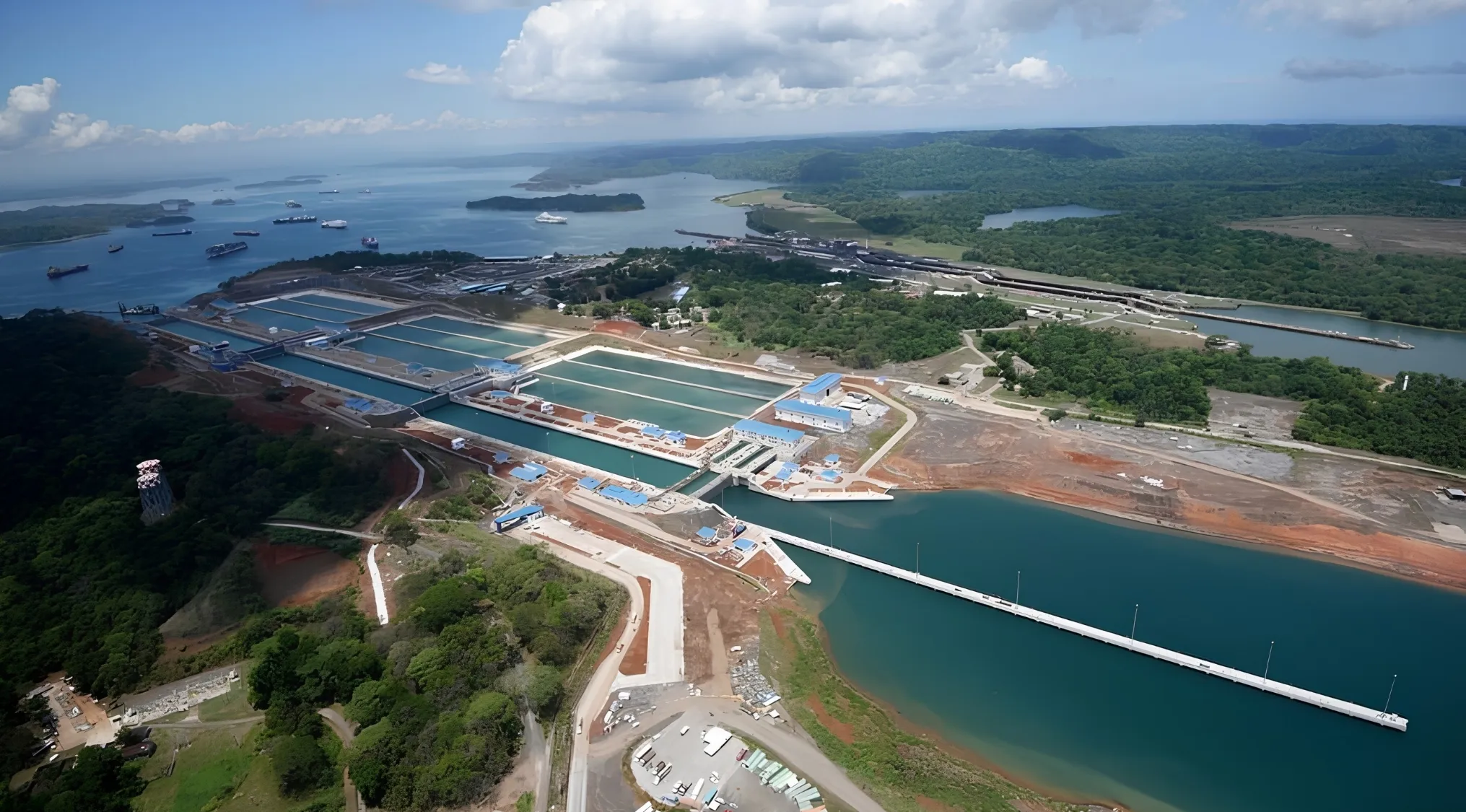 Aerial view of the country's canal, a vital waterway connecting the Caribbean Sea and Pacific Ocean, surrounded by lush landscape.