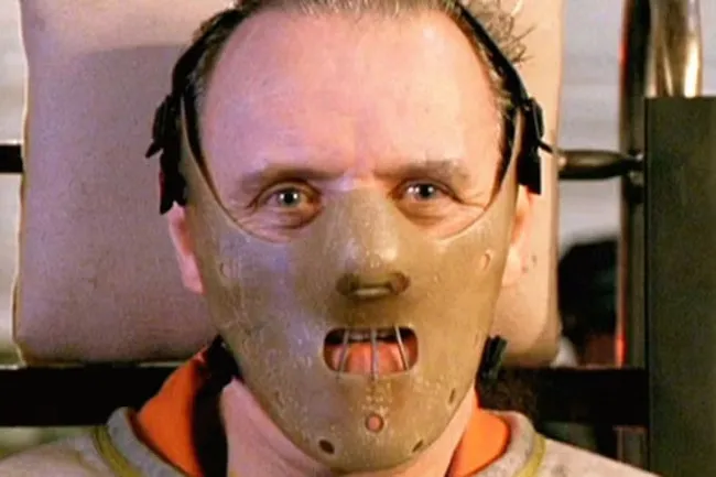 A close-up of Hannibal Lecter wearing his iconic mask, a classic movie villain for a themed birthday celebration.