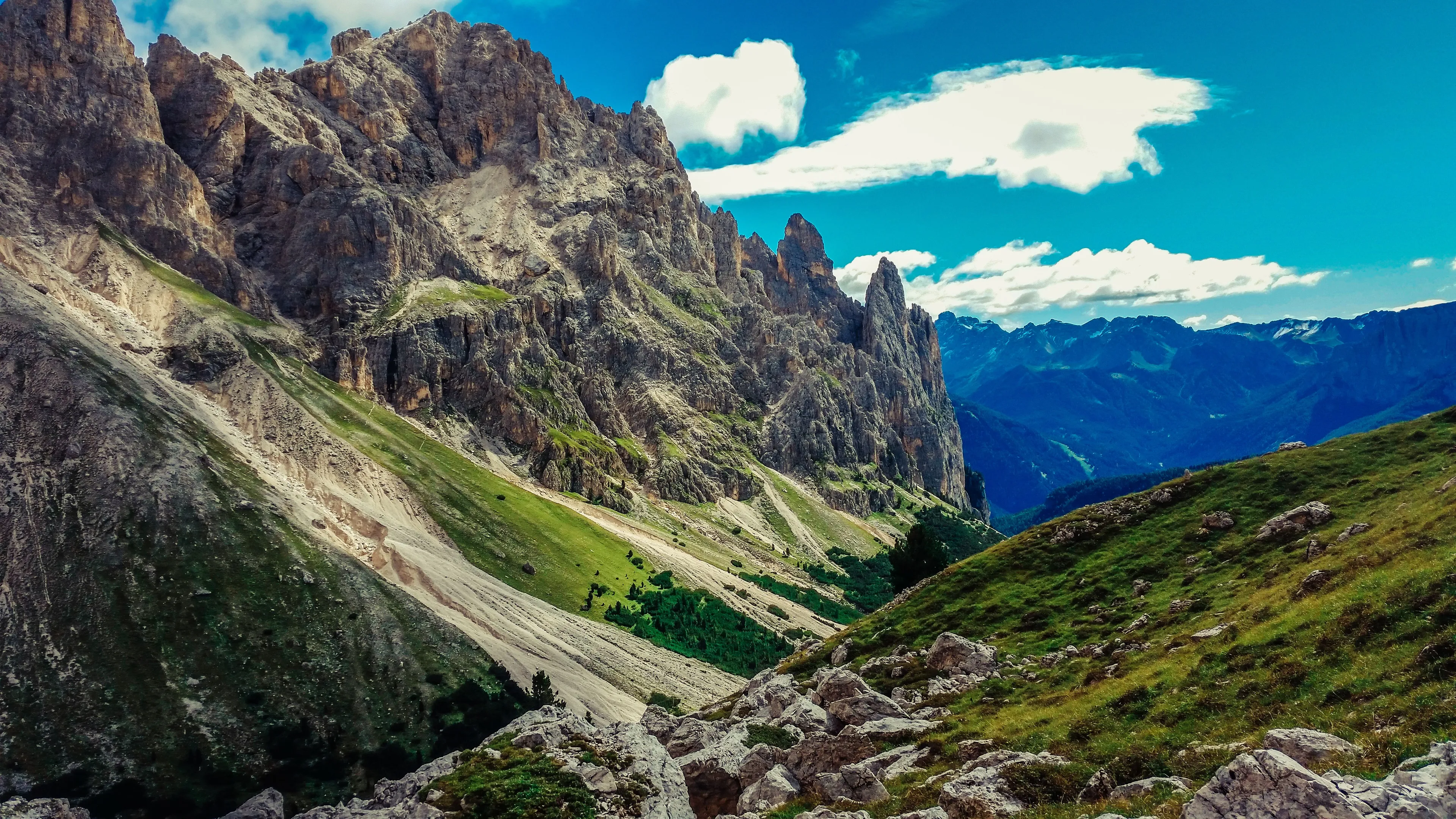 The Dolomites offer stunning mountains, green valleys, and a clear blue sky, perfect for a week-long escape.