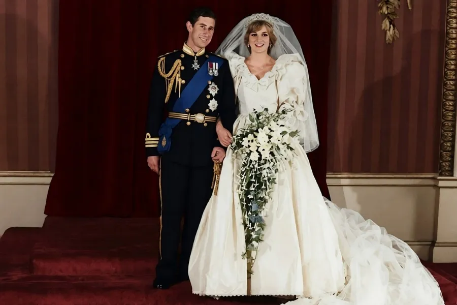 Princess Diana and Prince Charles get married, posing in their wedding attire.