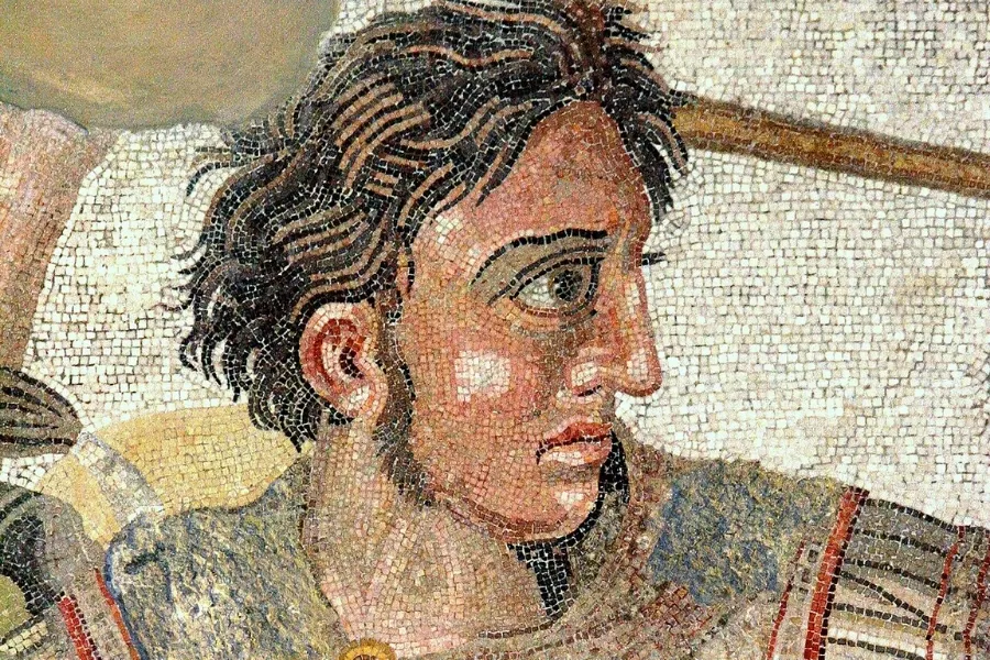 A detailed mosaic depicting the face of a young man, representing the birth of Alexander the Great.