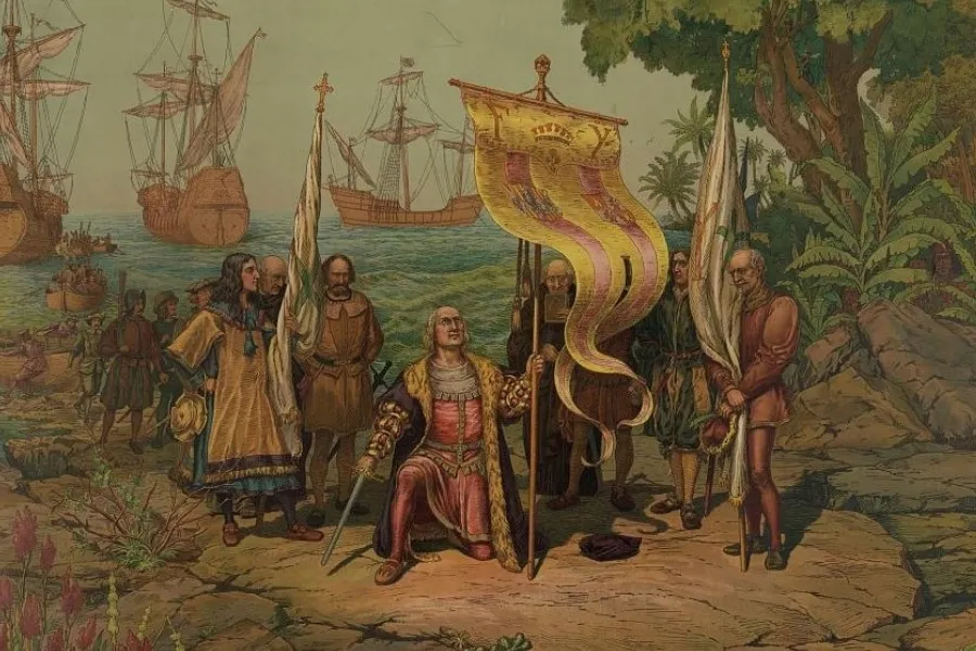 Painting depicting Christopher Columbus arriving in the Americas, kneeling on the shore with his crew and ships.