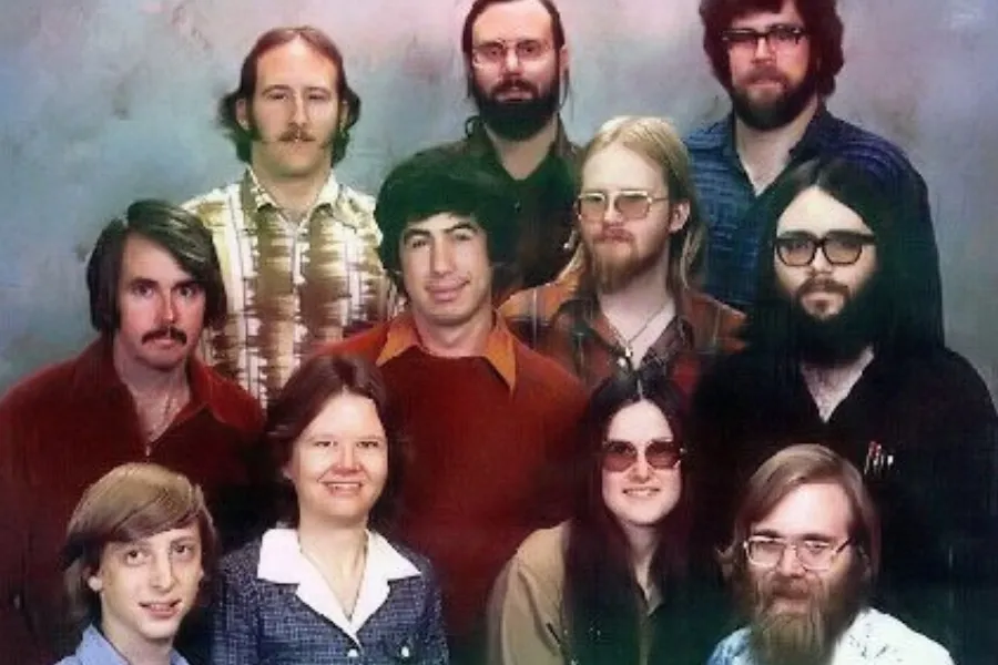 An early group photo of the Microsoft team, including Bill Gates, signifying the founding of Microsoft.