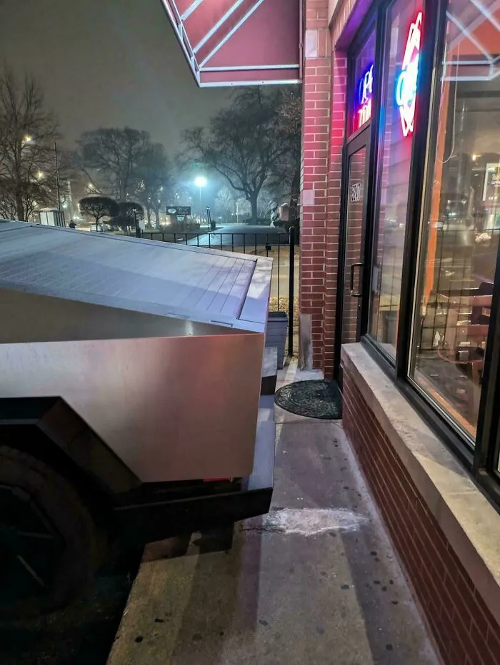 Someone Parked Their Cybertruck Where It Blocks Half Of The Sidewalk And Nearly Prevents The Door To This Business From Being Opened