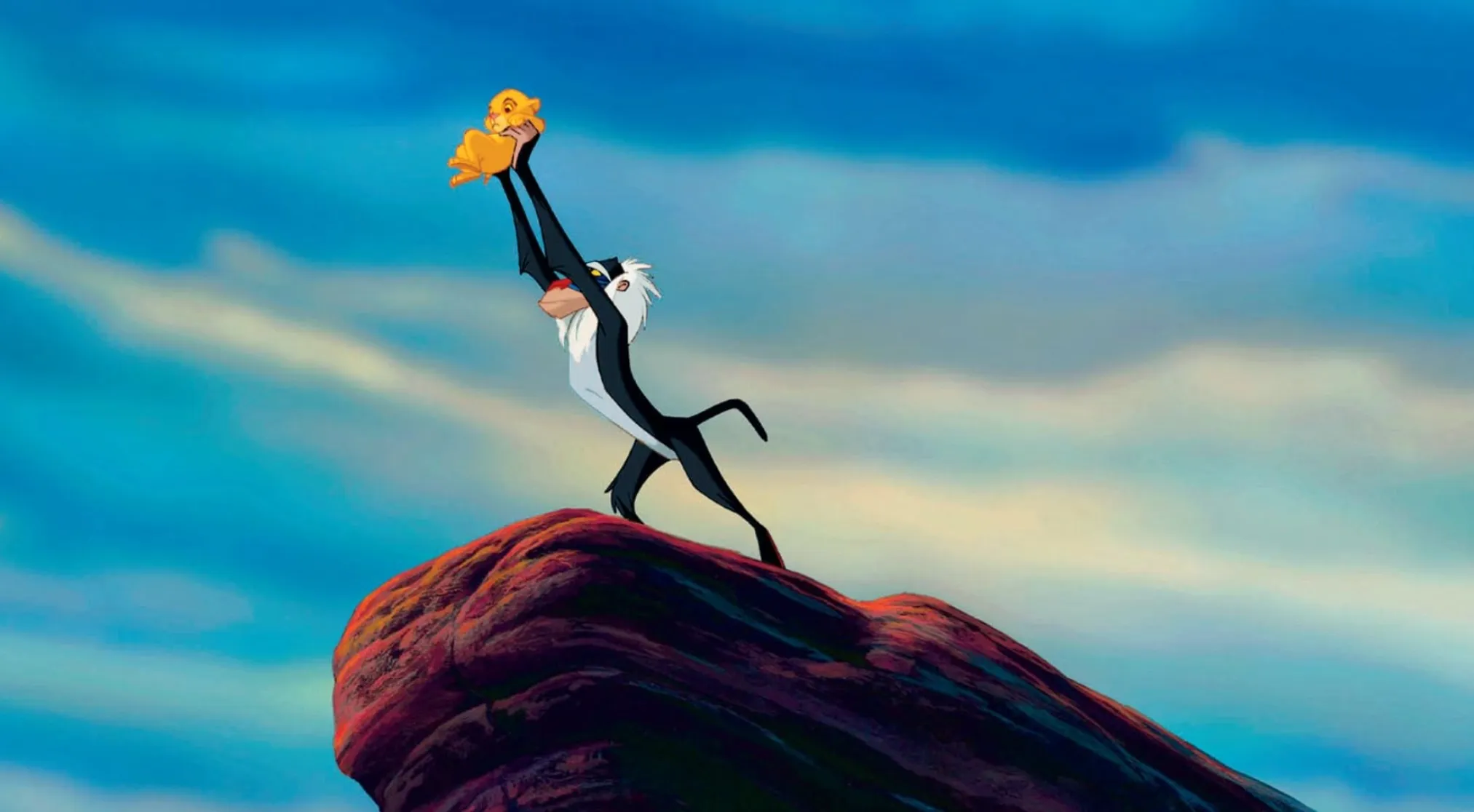 Rafiki holds baby Simba up to the sky on Pride Rock for 80s & 90s General Movie Trivia.