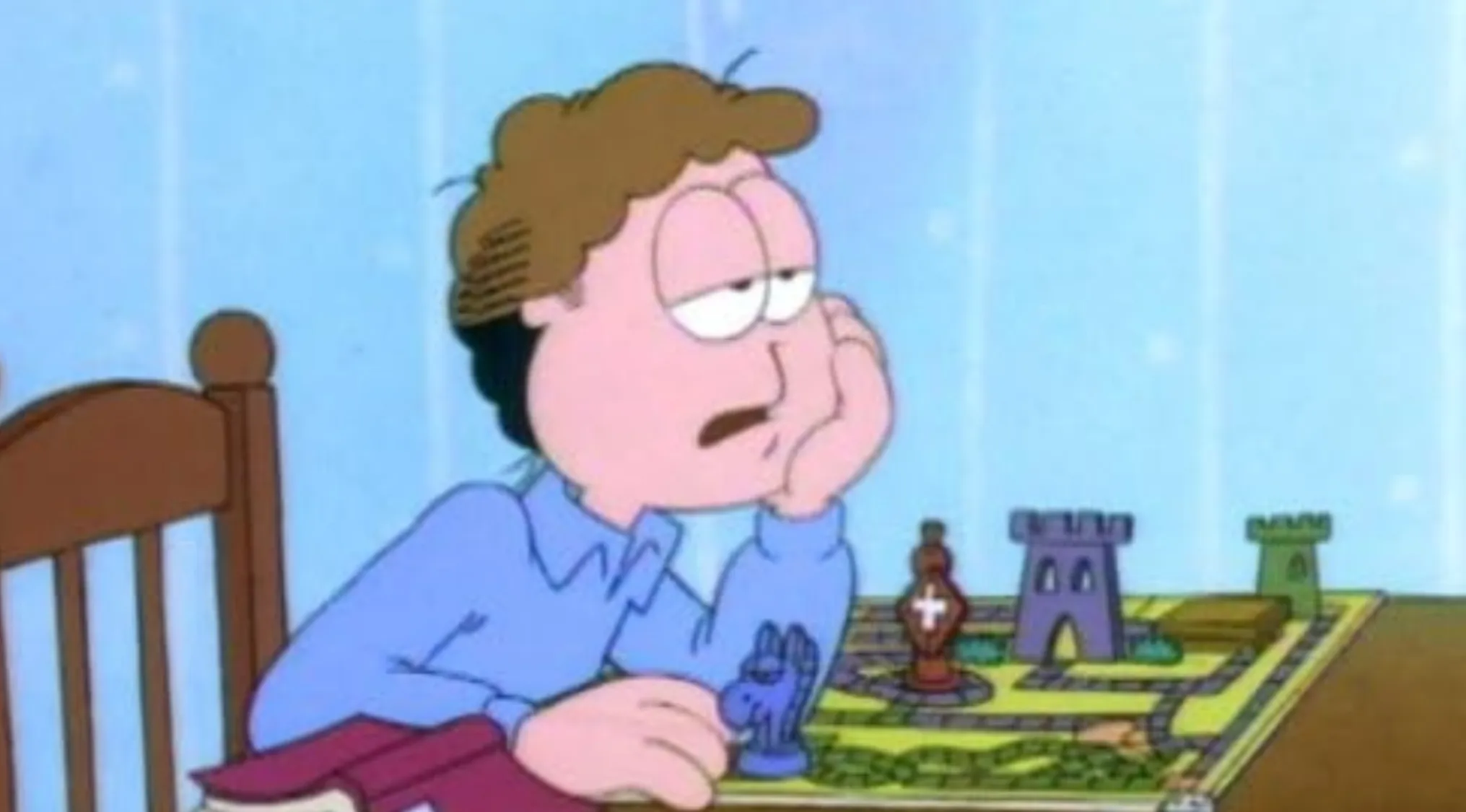 Jon Arbuckle, a character from Saturday Morning Cartoons, looking bored at a table with a game.