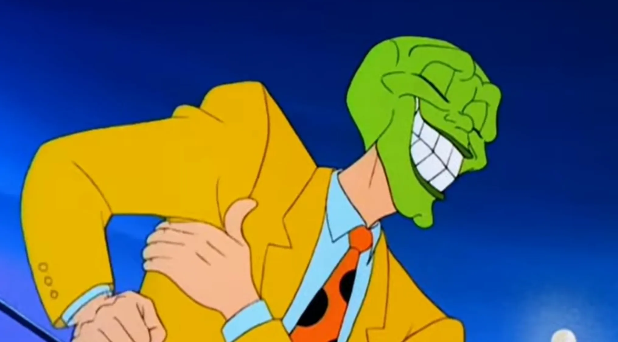 Stanley Ipkiss as The Mask in his green-faced form, wearing a yellow suit and orange polka dot tie.