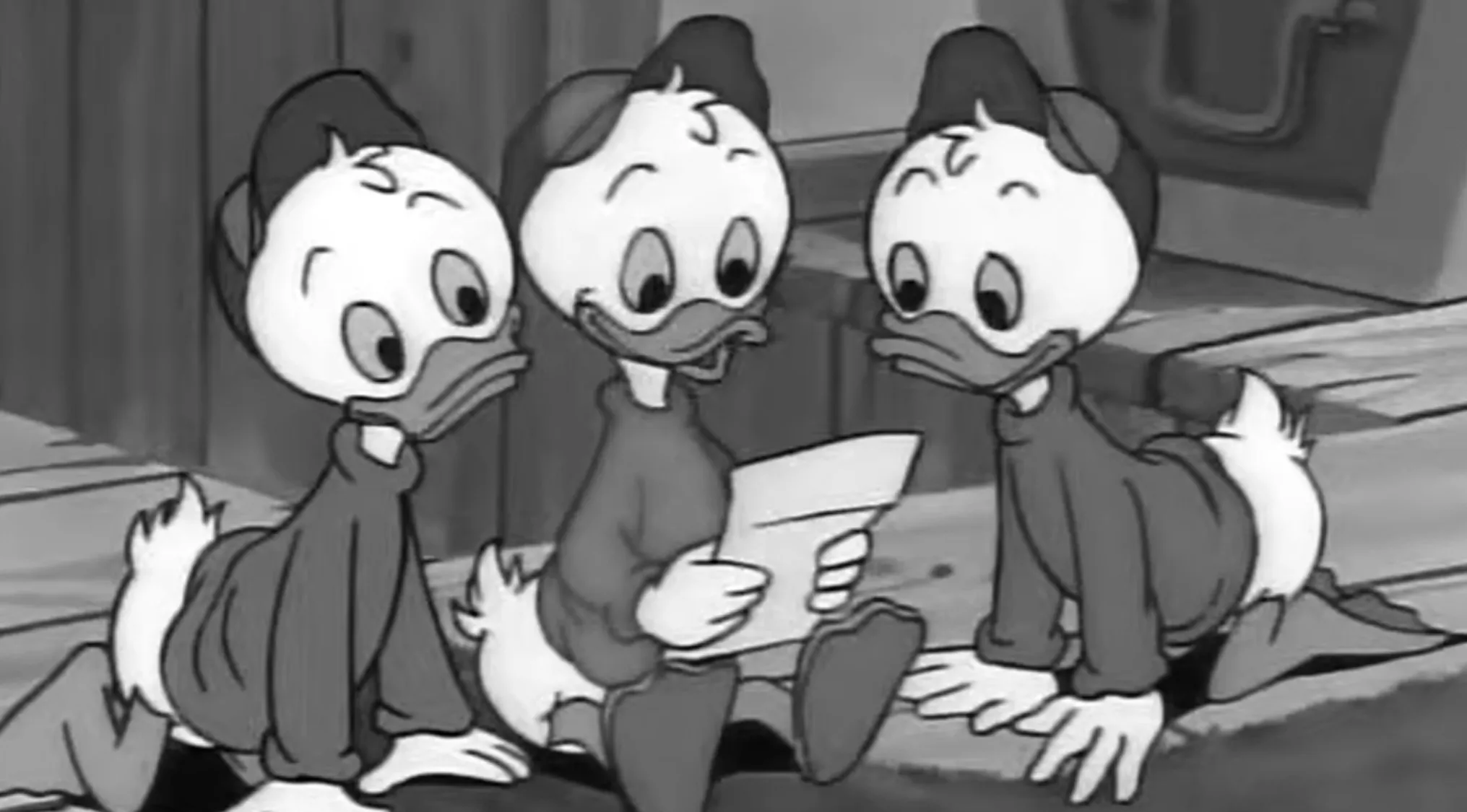 Three DuckTales characters in a black and white image, highlighting their shirts' colors.