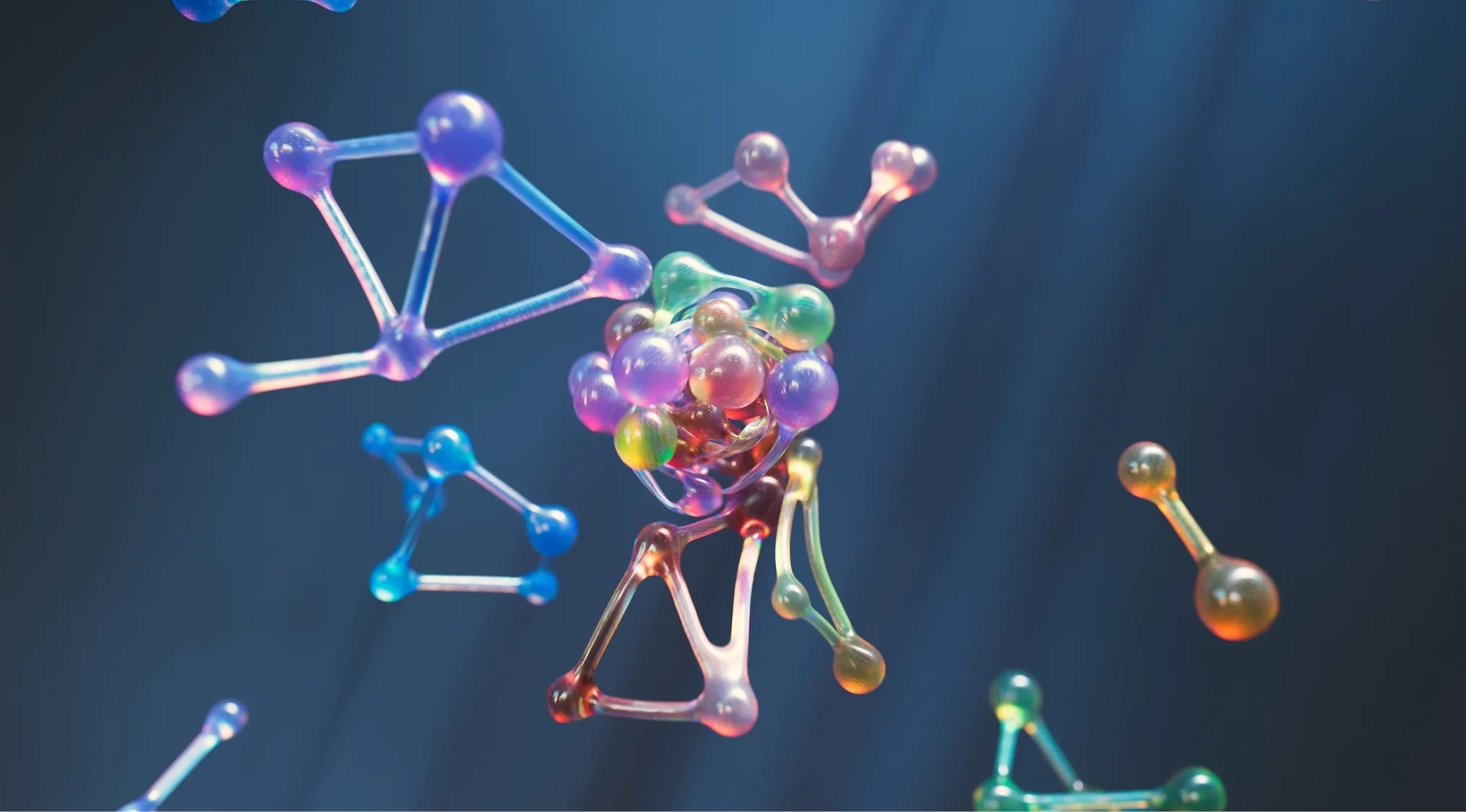 Colorful, glowing atom models floating in a dark blue space, illustrating key Science concepts. School Questions.