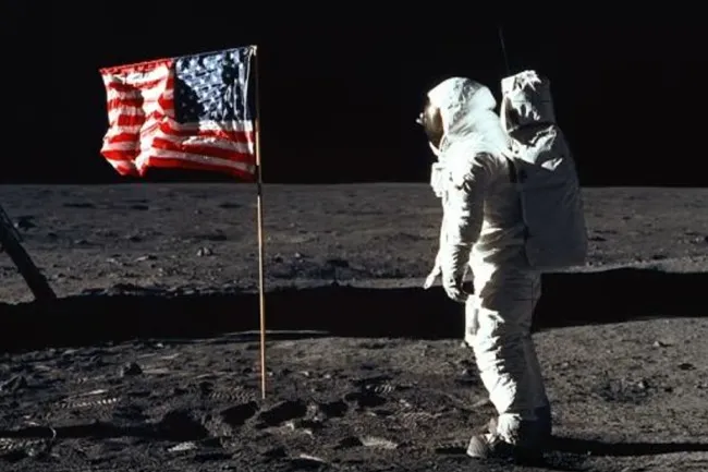Astronaut on moon with American flag, sparking debate about whether the moon landing was staged.