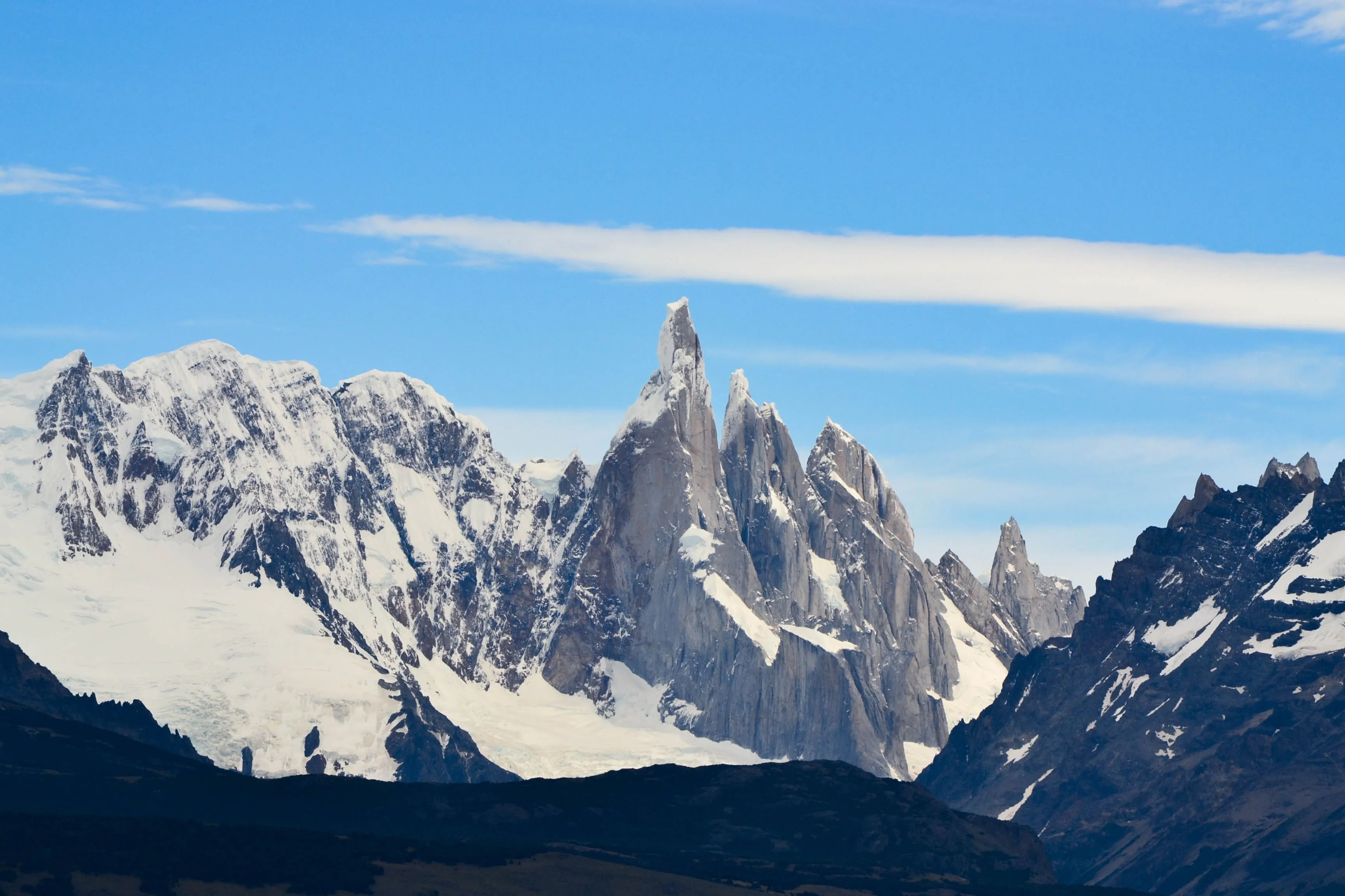 Majestic snow-capped peaks of Patagonia rise under a clear blue sky, a breathtaking pick a place to visit.