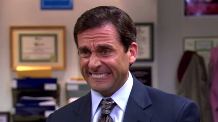 Michael Scott, a fictional character, making a funny face, identifying with a character