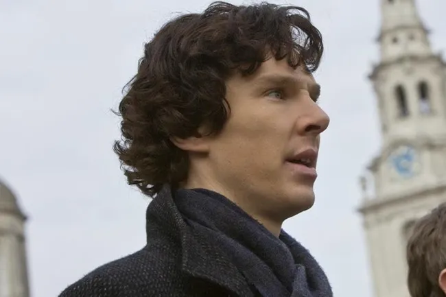 Sherlock Holmes, a fictional character, looking intently to the side.