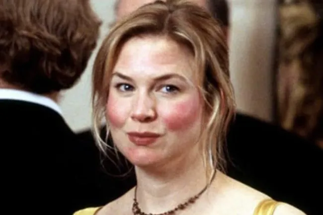Bridget Jones, a fictional character, smiling slightly at an event.