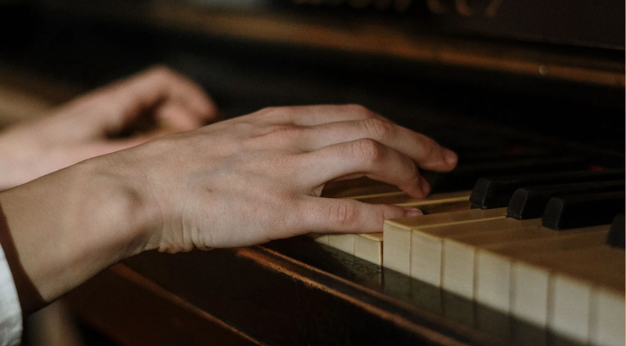 Close-up of hands playing the piano, related to the Moonlight Sonata and general music knowledge.