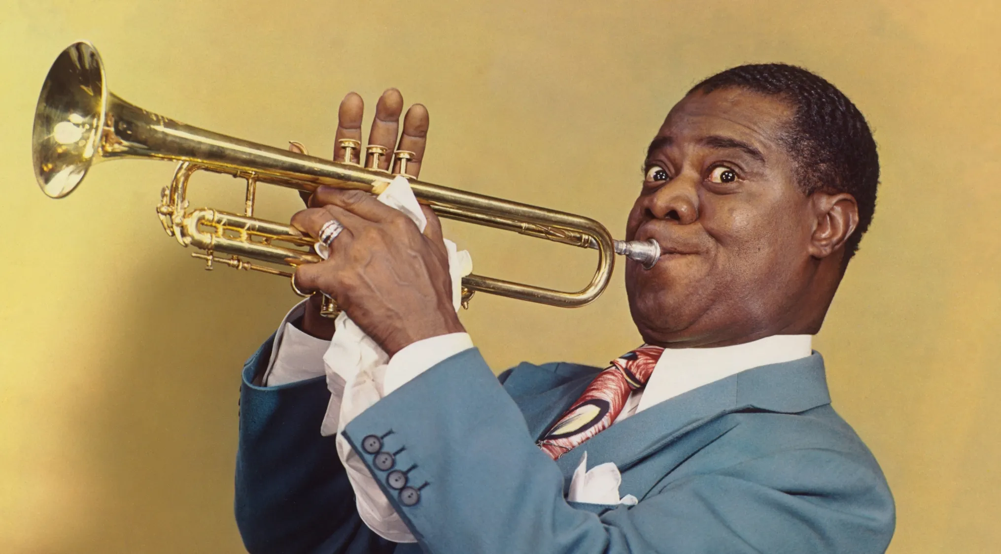 Louis Armstrong, a famous jazz musician, playing his trumpet.