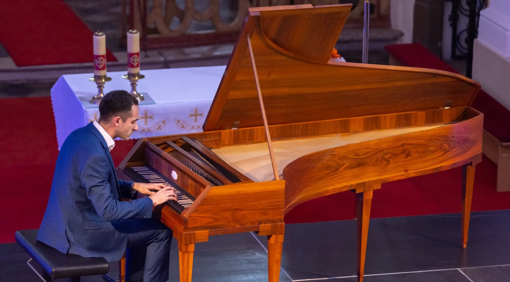 A man playing a fortepiano, a musical instrument that combines two musical terms.