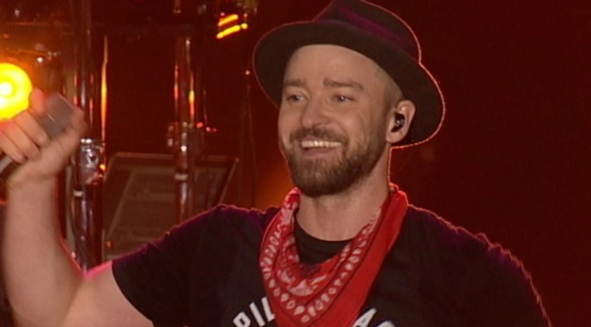 Justin Timberlake smiling and holding a microphone, performing on stage. General music knowledge part 4.