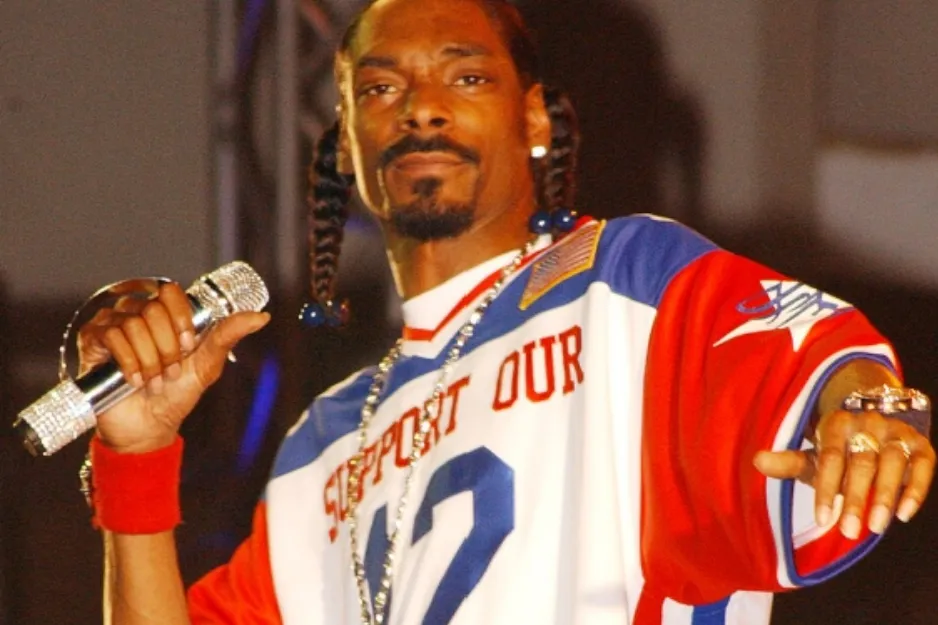 Rapper Snoop Dogg, known for alter ego Slim Shady, holding a microphone while performing.