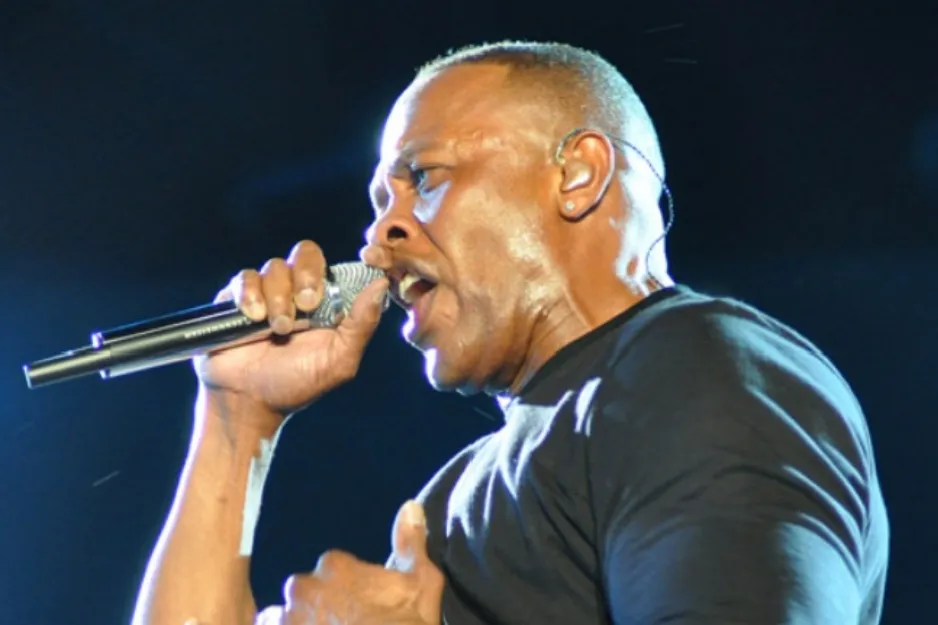 Rapper Dr. Dre, known for alter ego Slim Shady, performing into a microphone.