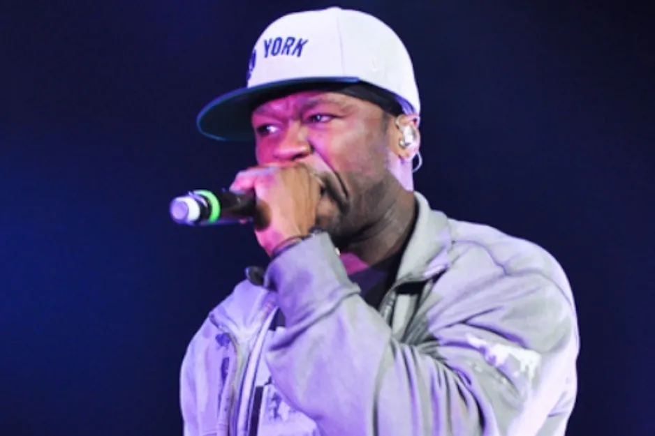 Rapper 50 Cent, known for alter ego Slim Shady, wearing a cap and performing into a microphone.